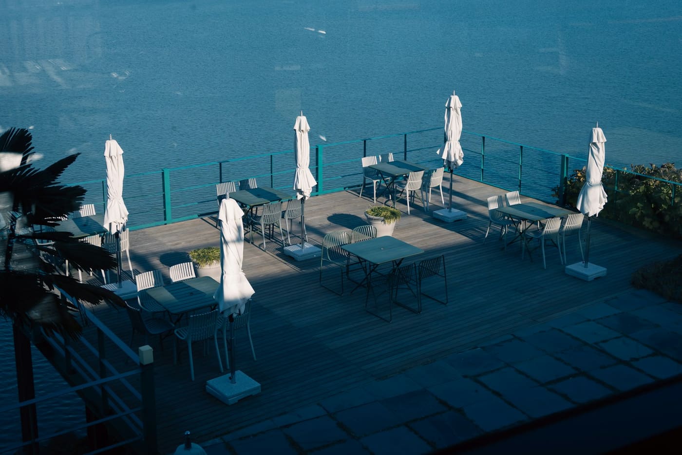 Korean outdoor waterfront pool with loungers and parasols
